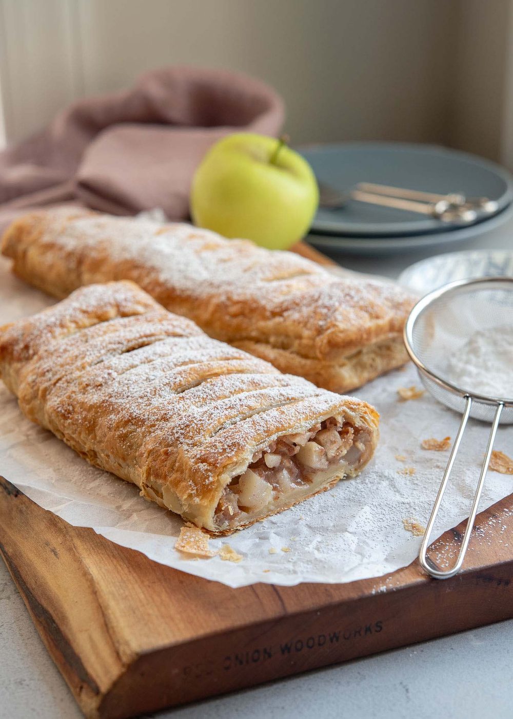 Sliced apple strudel revealing tender apple filling inside