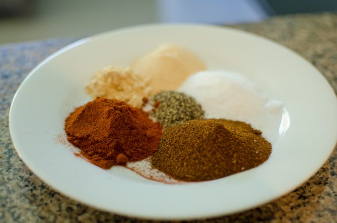 Various spices are collected to make kitchen-made dry rub for barbecue.