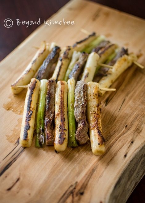 Beef, rice cake, and green onion are skewered together and pan-fried.