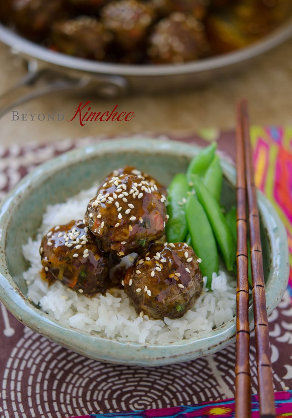 Juicy meatballs coated in pineapple soy glaze beside steamed rice