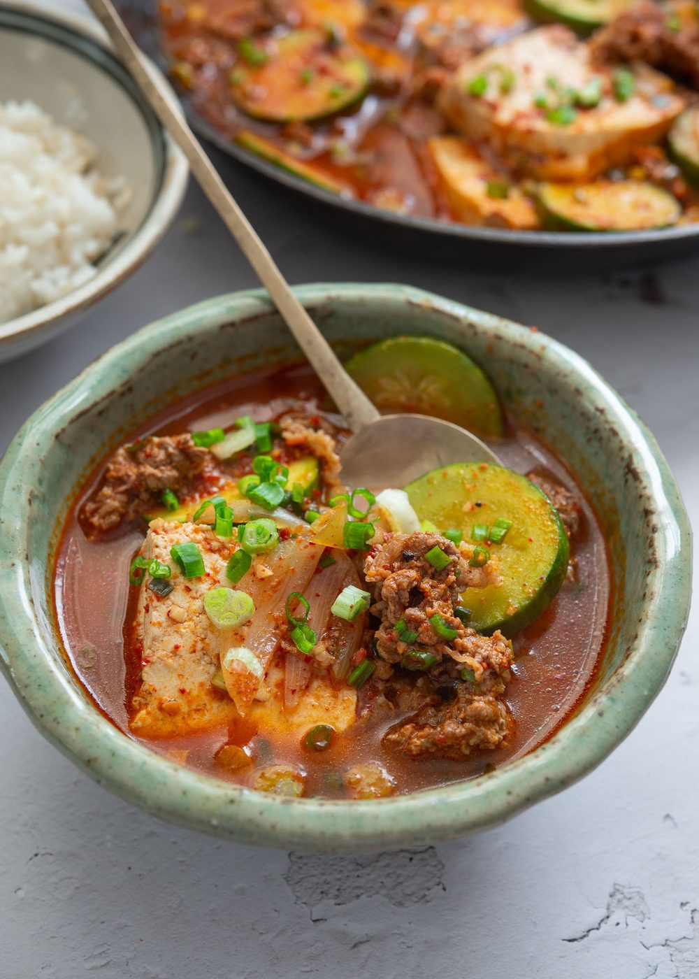A bowl of beef tofu stew served with rice.