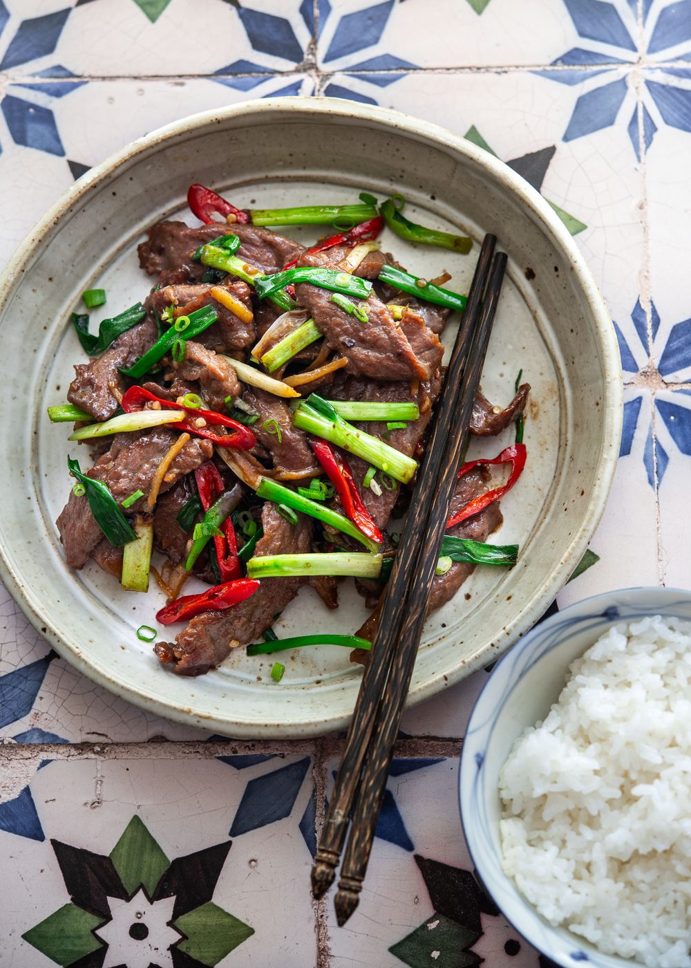 Ginger beef stir-fry plated with steamed rice for a short and direct Asian dinner.