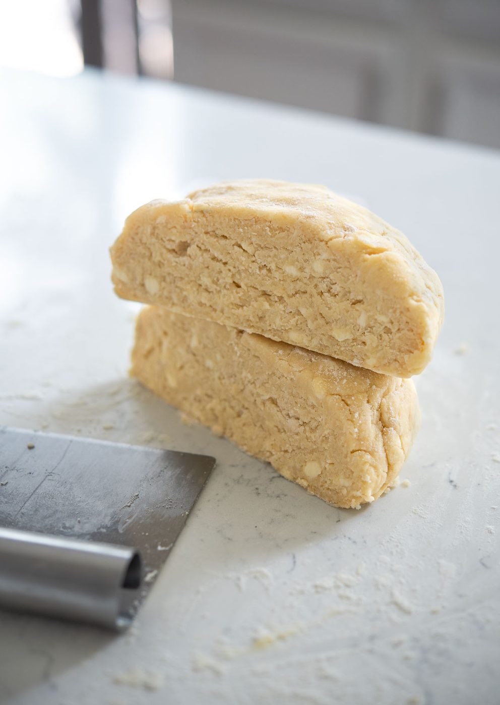 Pie dough with lard and butter showing visible fat pieces for flakiness