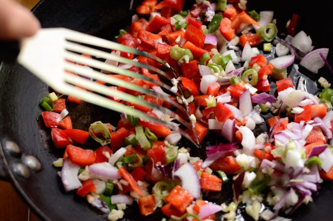 Vegetables cooking in a skillet.