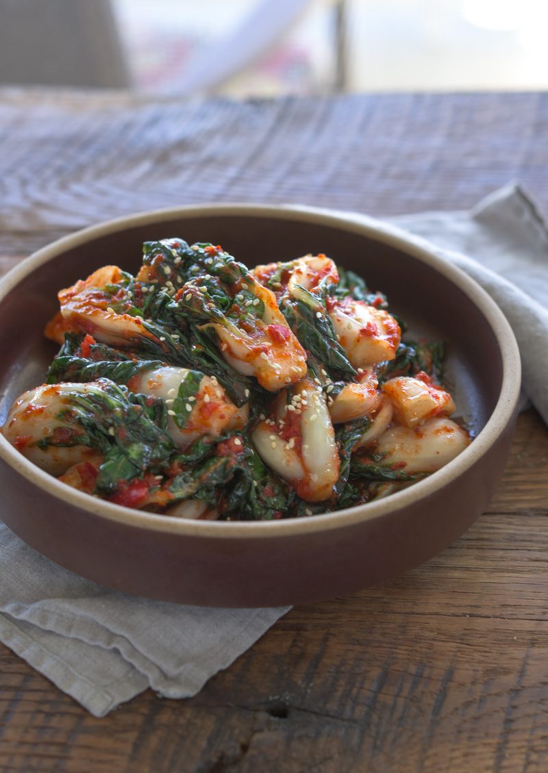 Bok choy kimchi in a stone serving bowl.