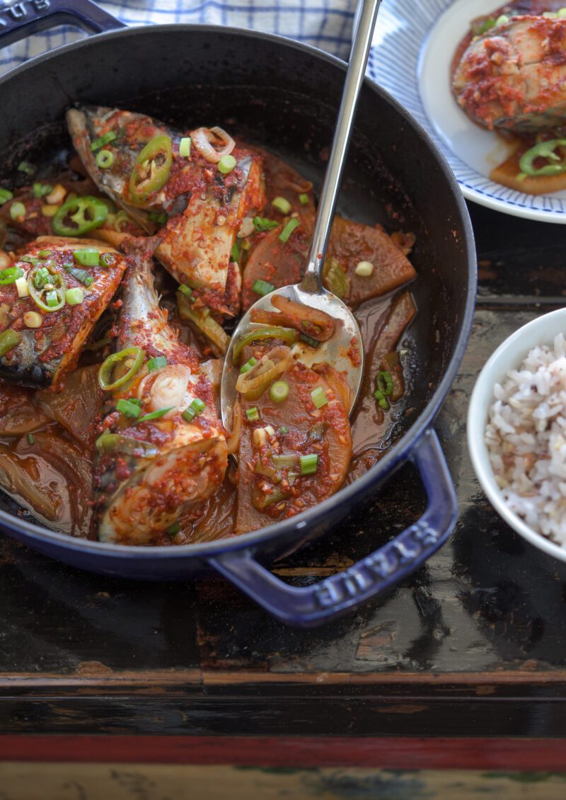 Fresh mackerel fish is braised with radish in a Korean chili sauce