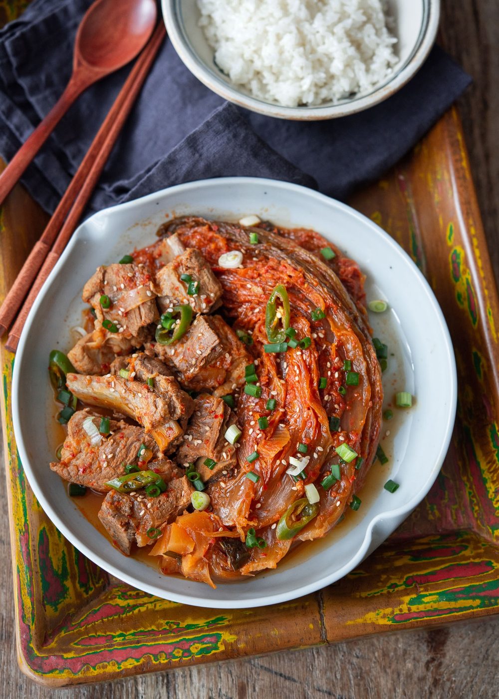 Braised kimchi and pork ribs (kimchi jjim) served on a plate with steamed rice