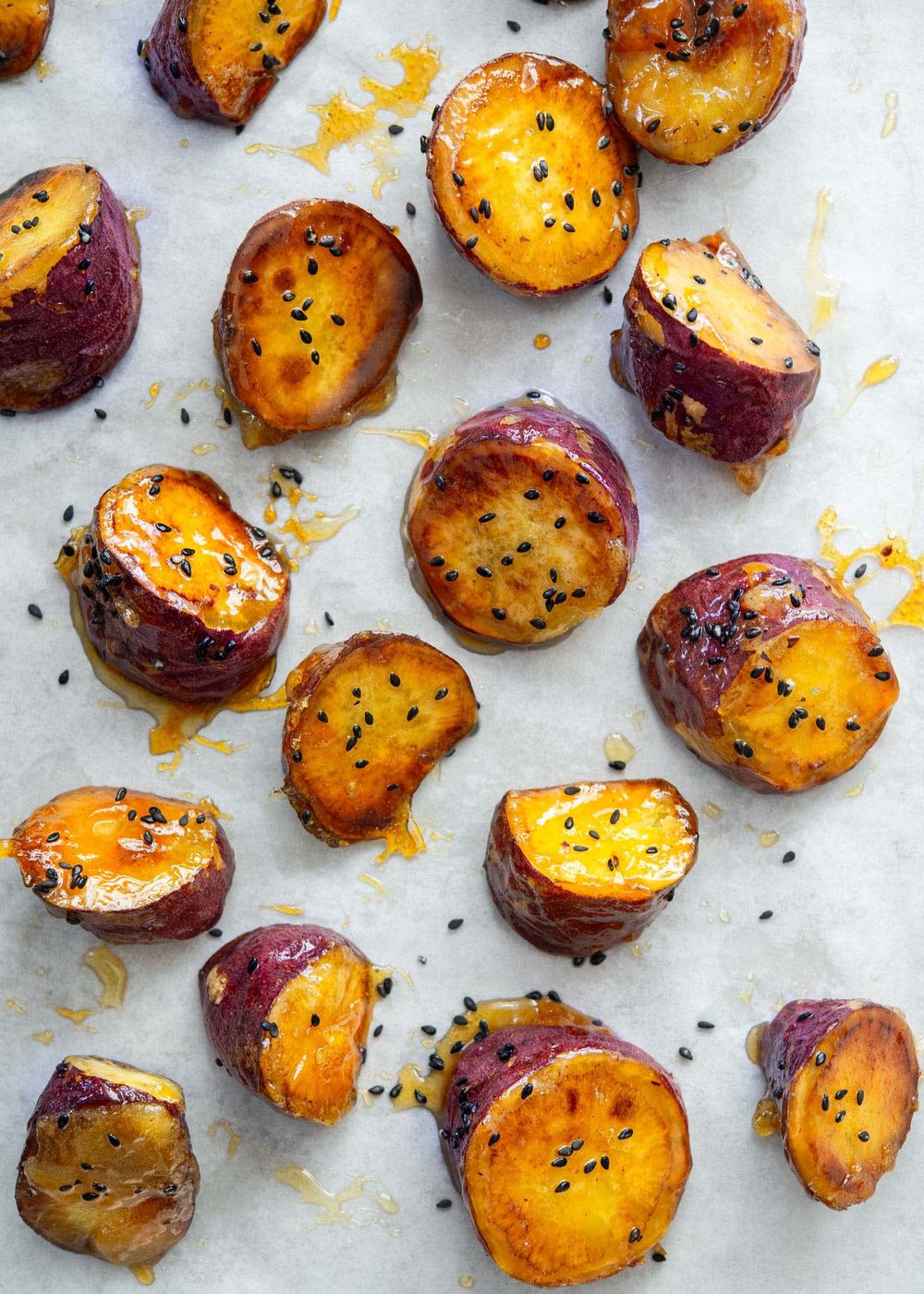 Candied Korean sweet potato with crunchy shell on parchment paper.