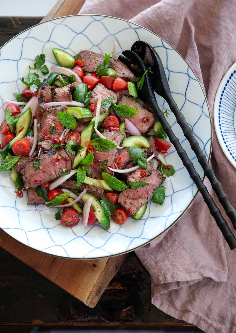 Classic Thai beef salad (Yum Nua) served with grilled steak, fresh herbs, and lime dressing