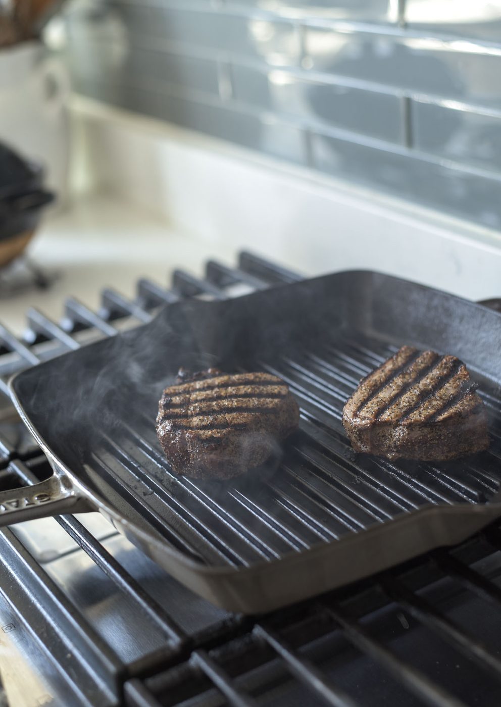 Sizzling beef tenderloin in a hot pan for Thai-style steak salad
