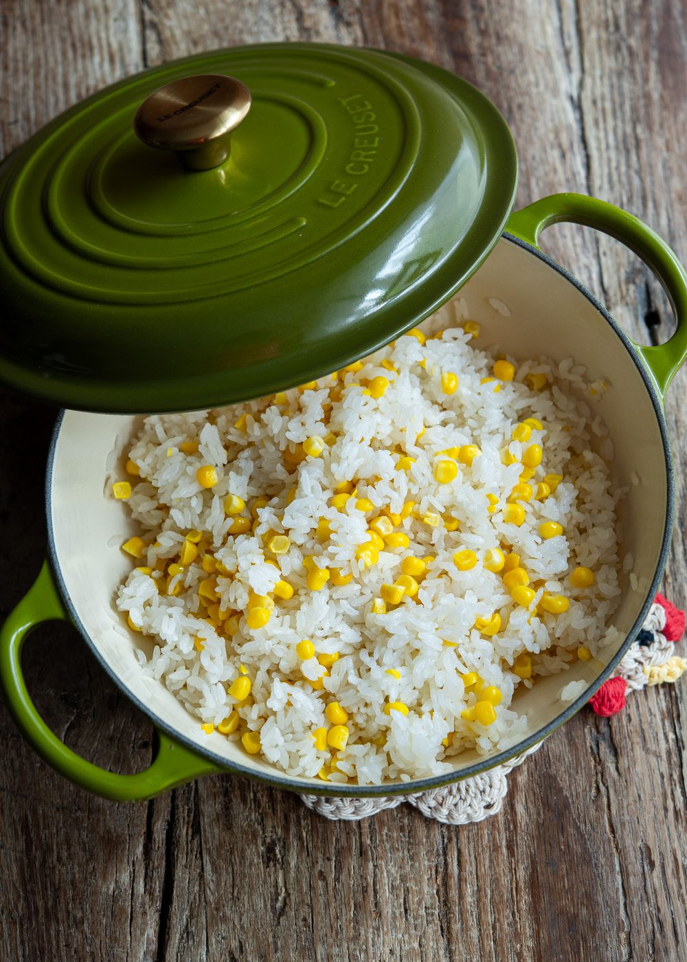 Fresh sweet corn and rice cooked together to make oksusu bap in a pot