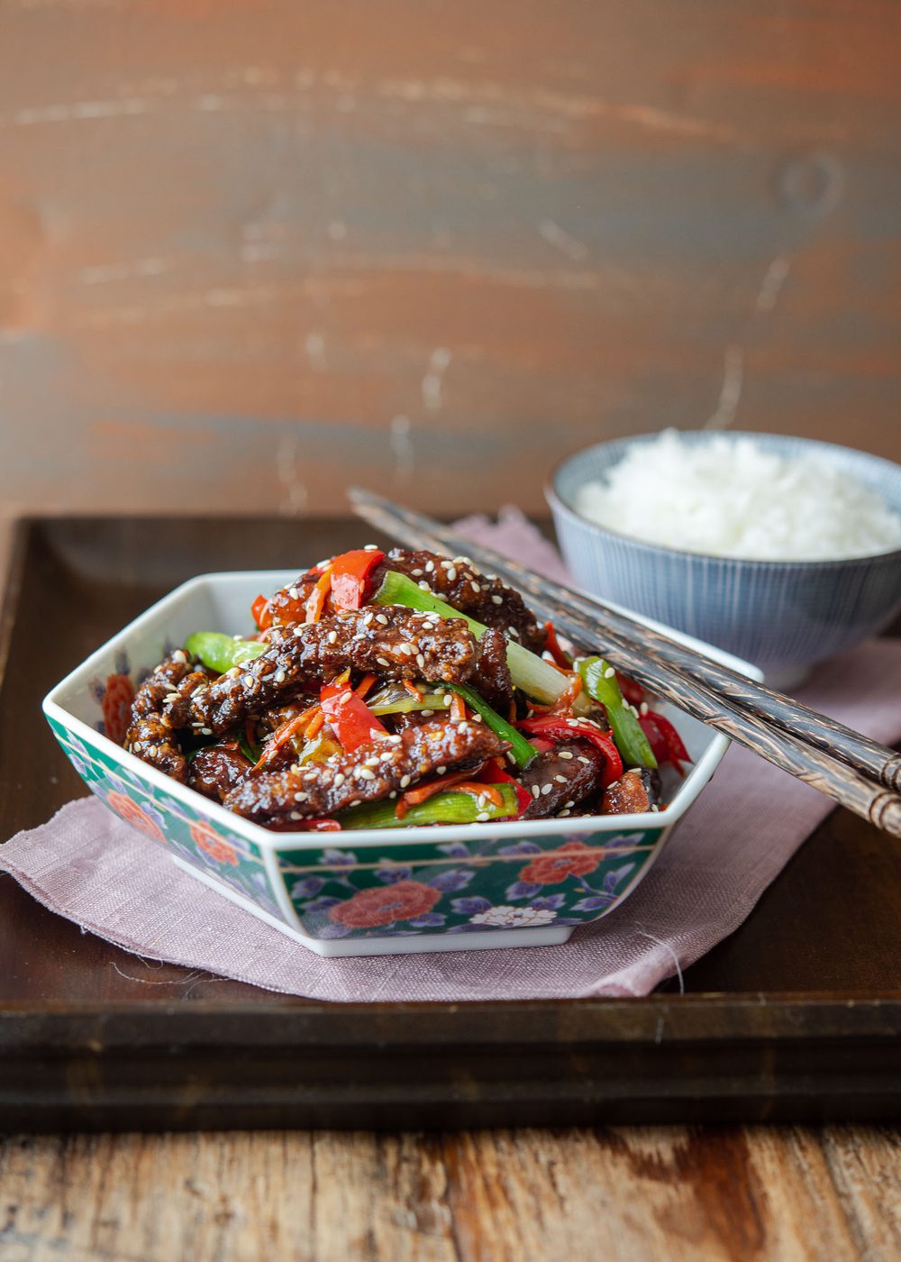Kitchen-made crispy beef in a sweet, tangy sauce served over rice