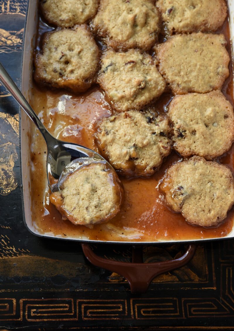 soft date dumplings are nestled in sweet brown sugar syrup.