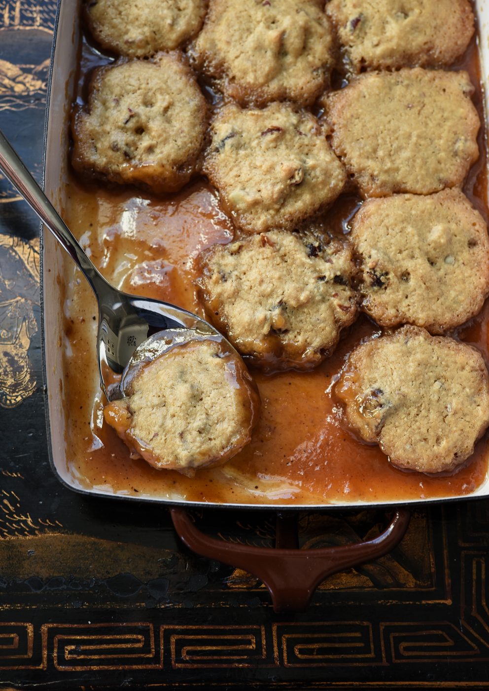 soft date dumplings are nestled in sweet brown sugar syrup