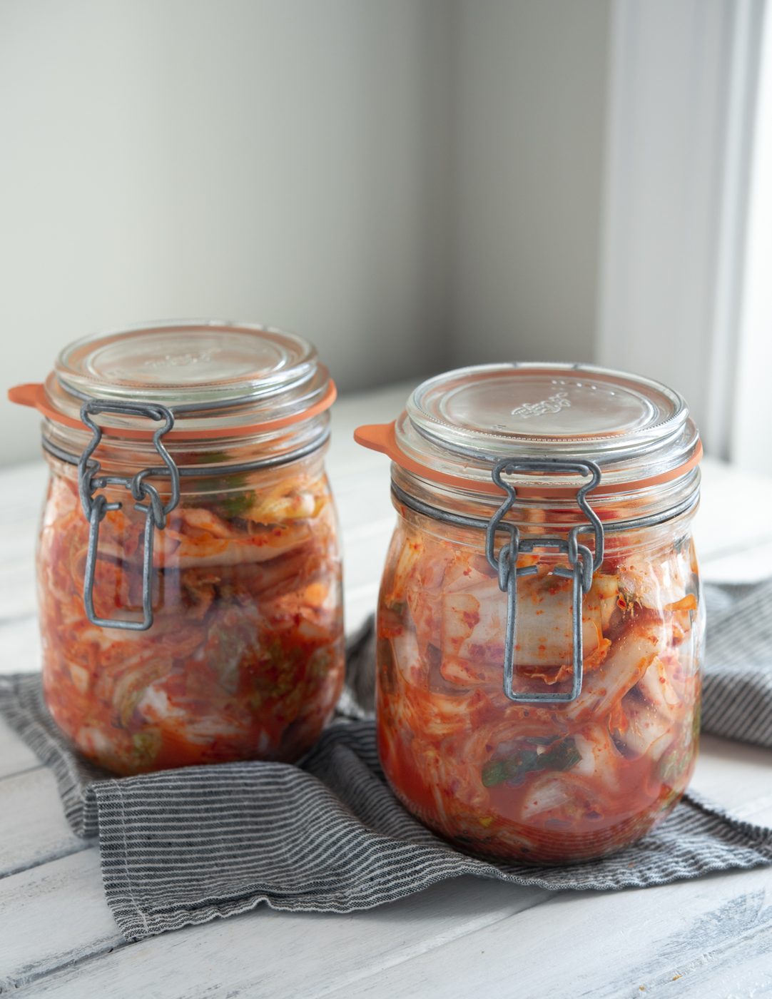 Direct cabbage kimchi (Mak-kimchi) is fermenting in two glass jars