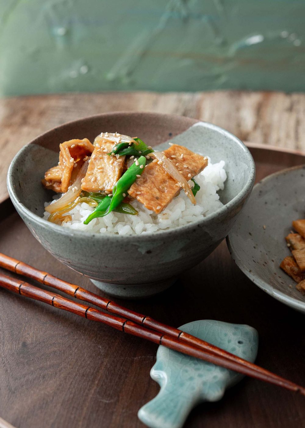 Eomuk bokkeum placed over a bowl of rice.