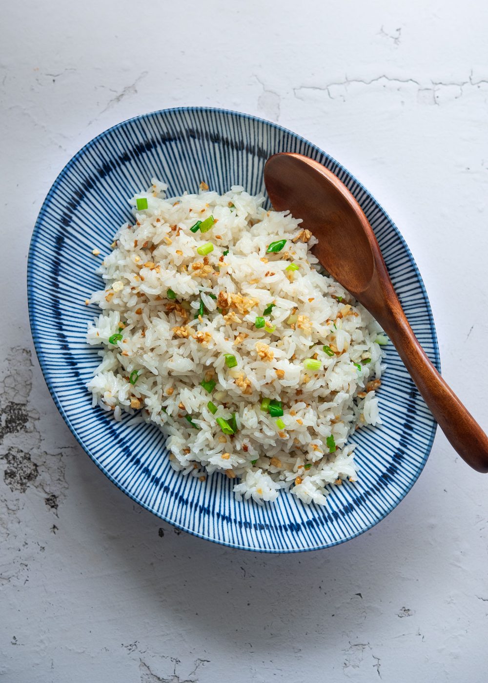 Garlic fried rice served in a bowl with a spoon.