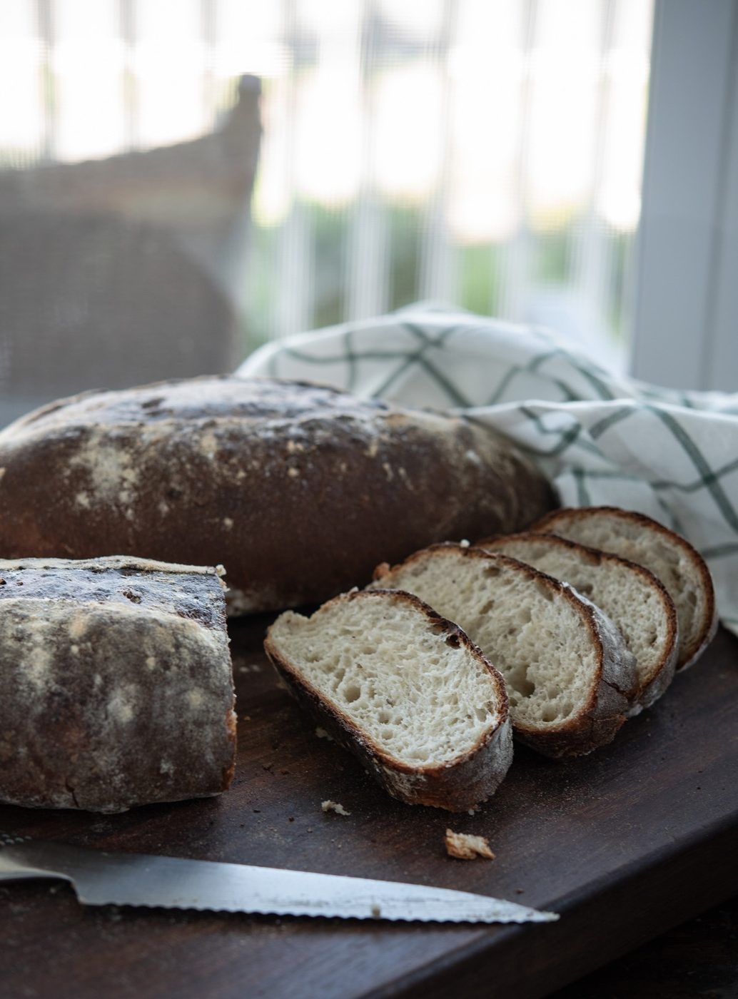 German potato bread sliced on a cutting board.