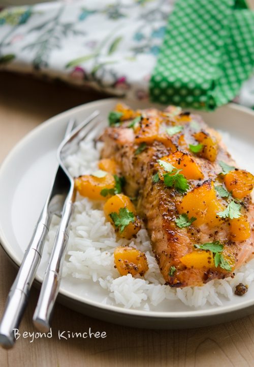 Salmon fillet is baked with mustard and peach glaze and served with rice.