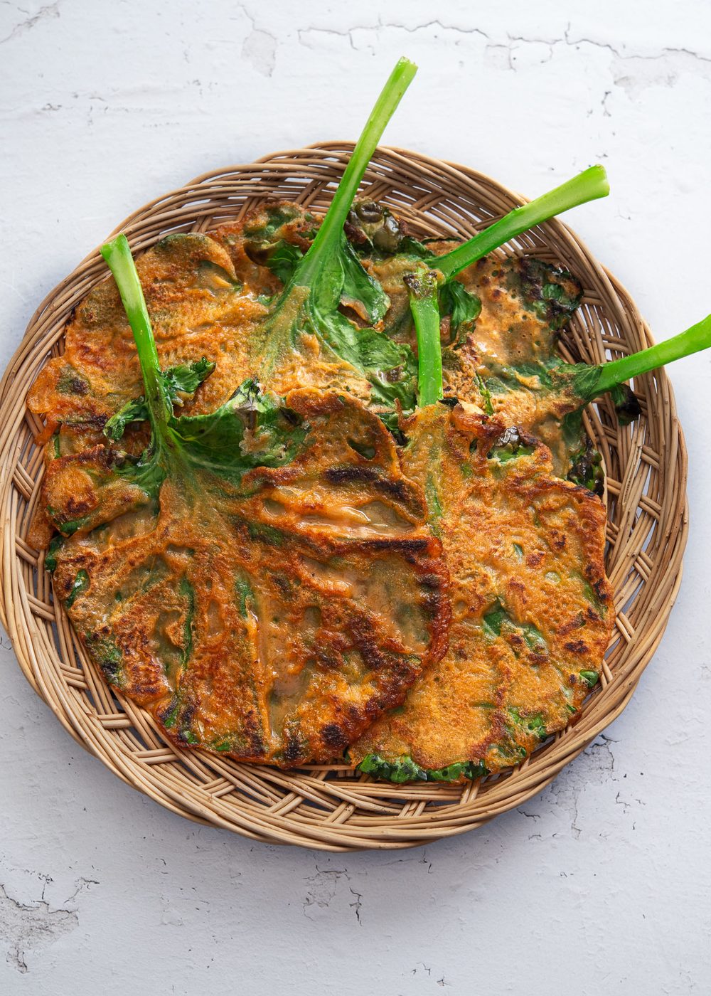 Kale gochujang pancakes in a basket tray.