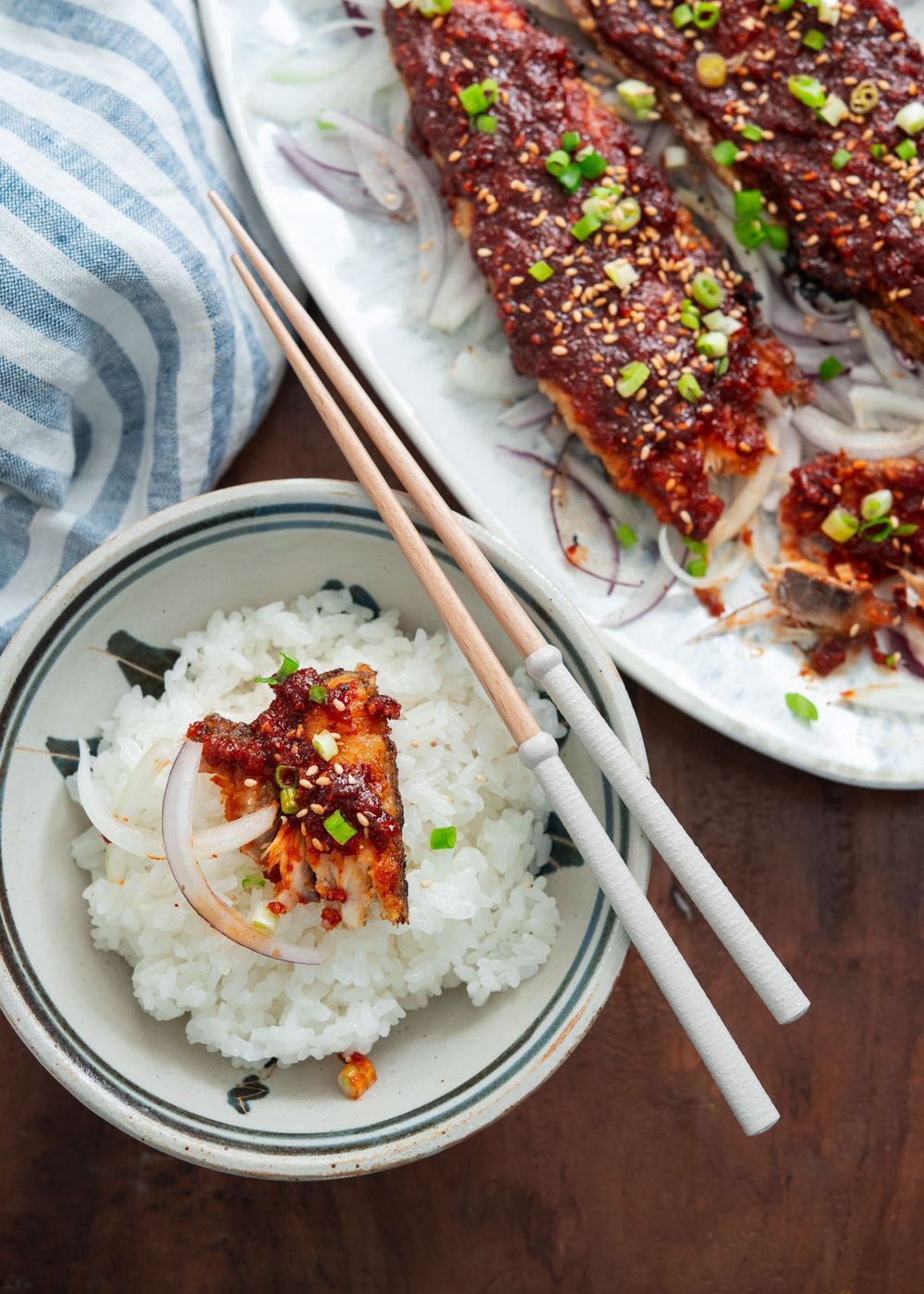 A piece of spicy mackerel over a bow of rice.