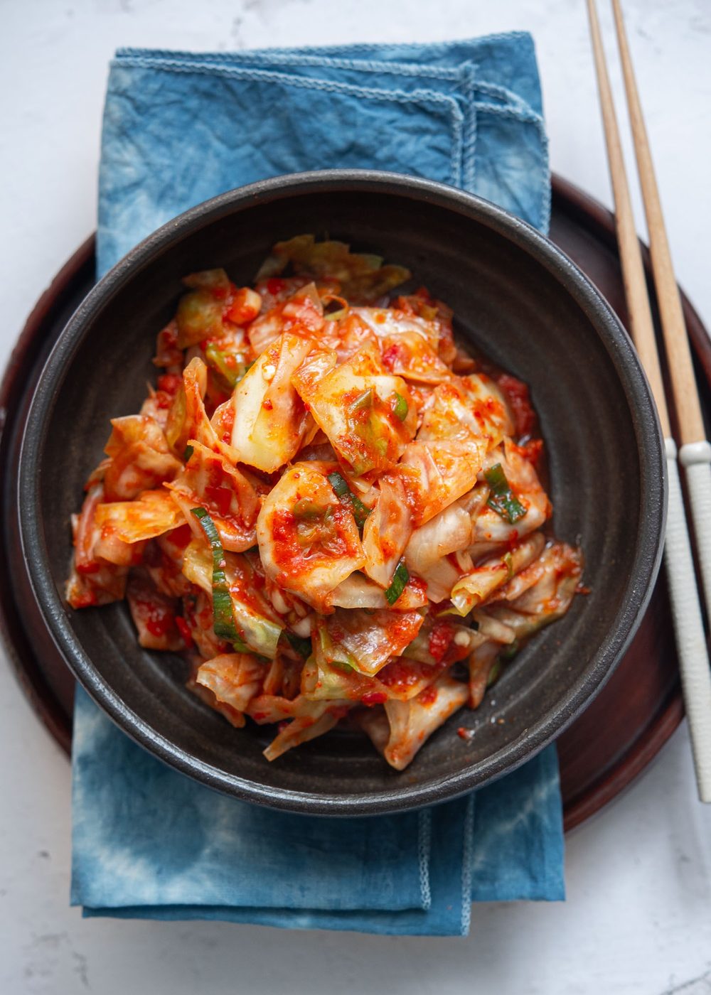 Green cabbage kimchi in a serving dish.