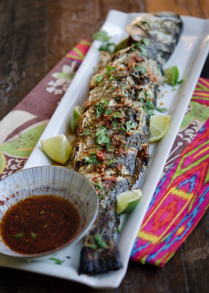 Grilled Fish is served with Soy Lime Chili Sauce and lime wedges