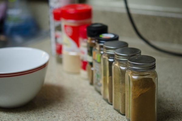 A variety of spices are lined up for making ham and cheese pastry puffs.