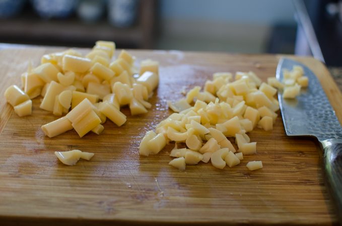 Canned hearts of palm is roughly chopped for cooking.