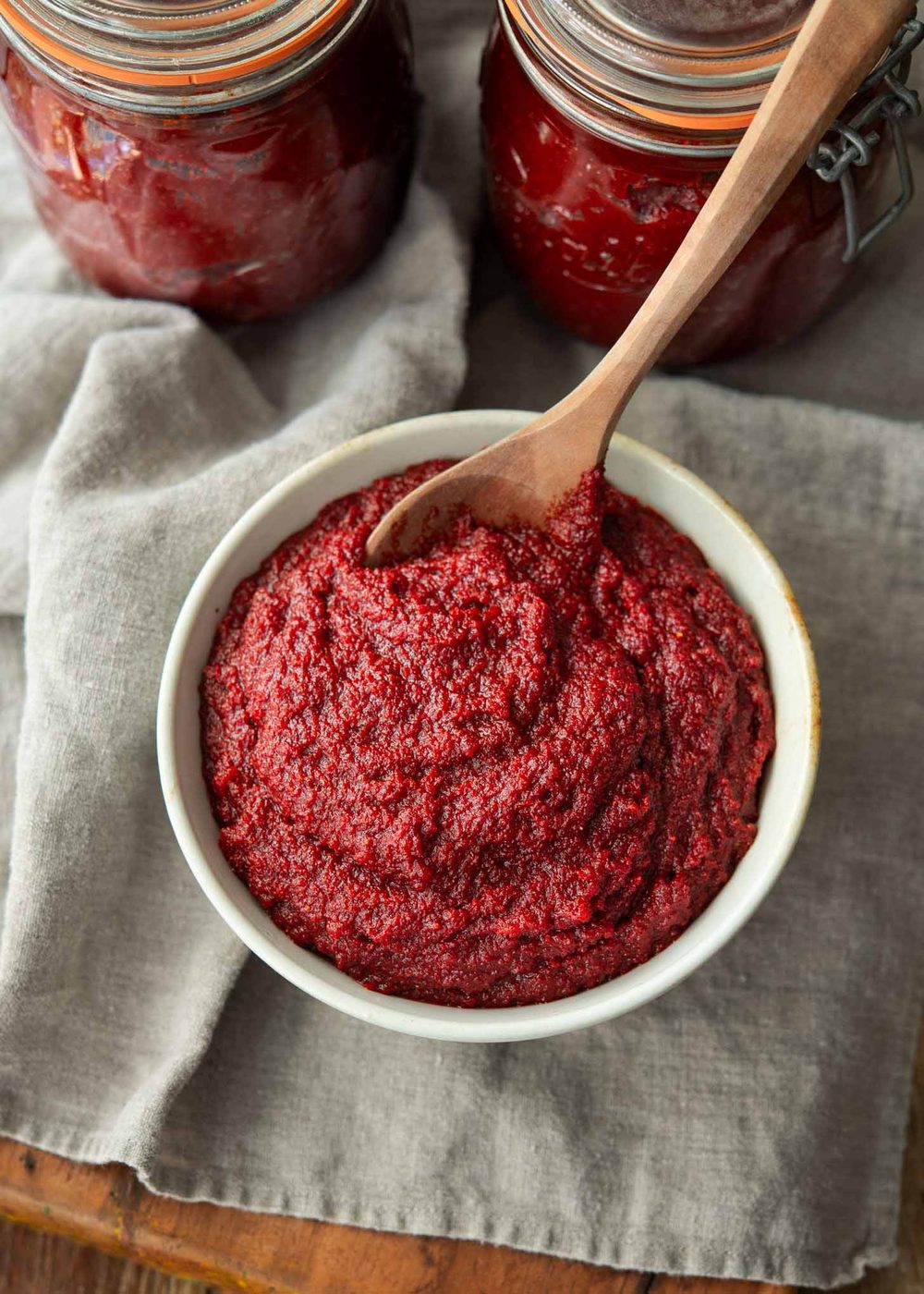 Kitchen-made Korean chili paste divided in a bowl and glass jars.