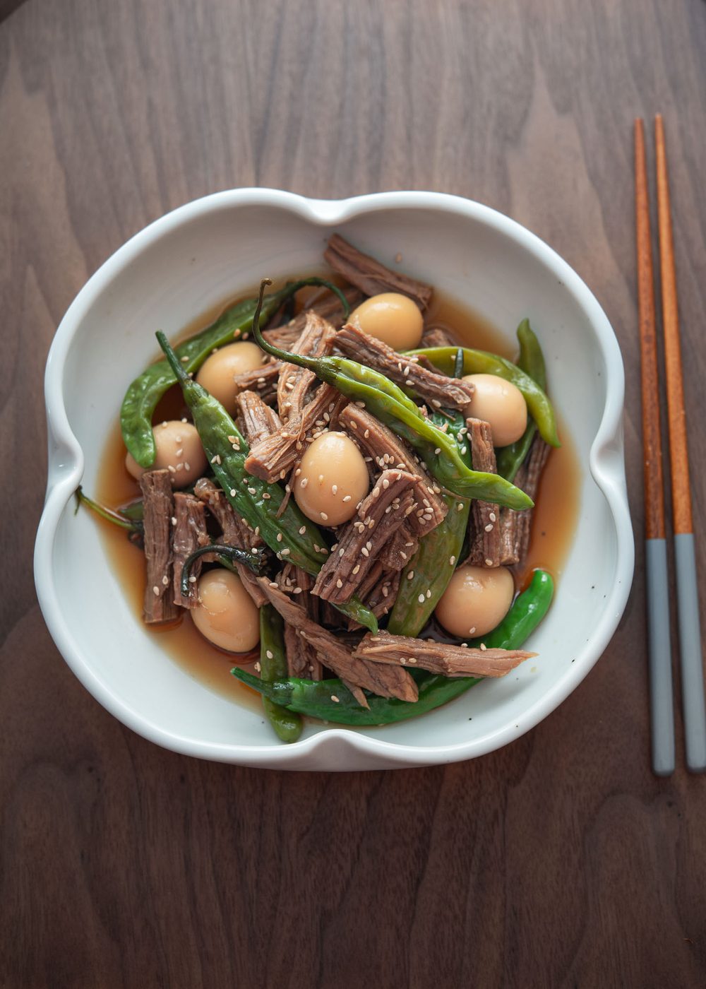 A plate of jangjorim with quail eggs and pepper.