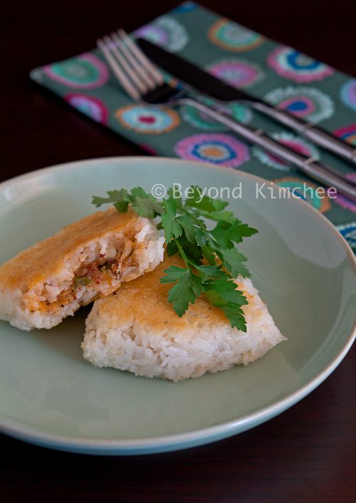 Pan-fried kimchi rice patties on a serving dish.