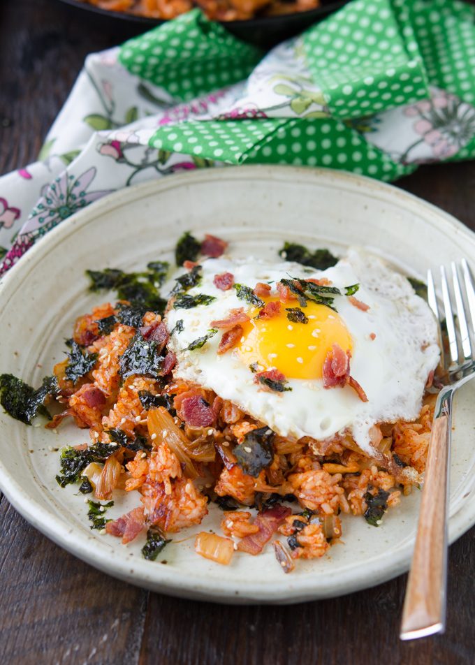 Bacon Kimchi Fried Rice is topped with a fried egg and seaweed.