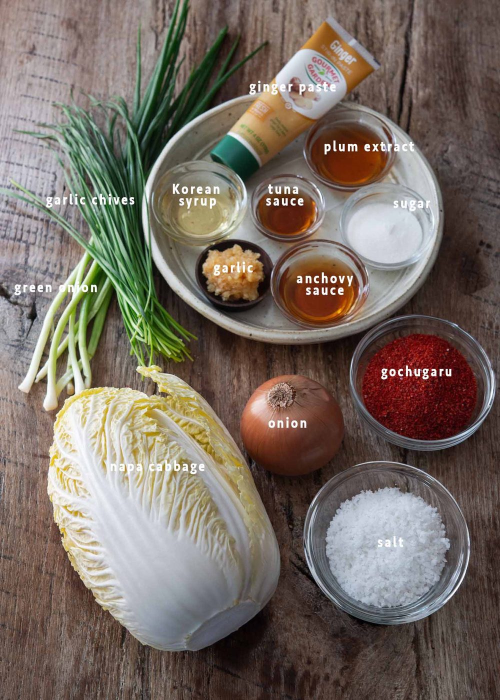 Recipe ingredients for kimchi salad (geotjeori) laid on the wooden board.