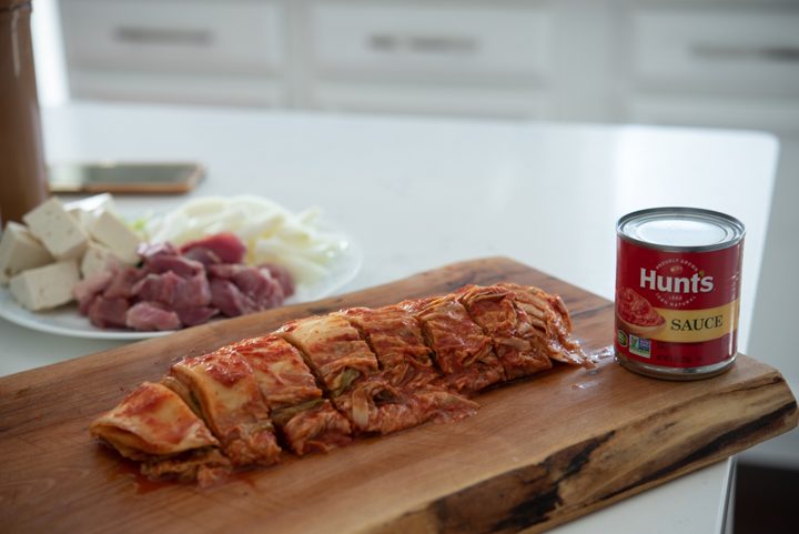 Sliced kimchi and a can of tomato sauce.