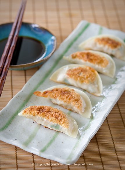 Pan fried dumpling on a serving platter.
