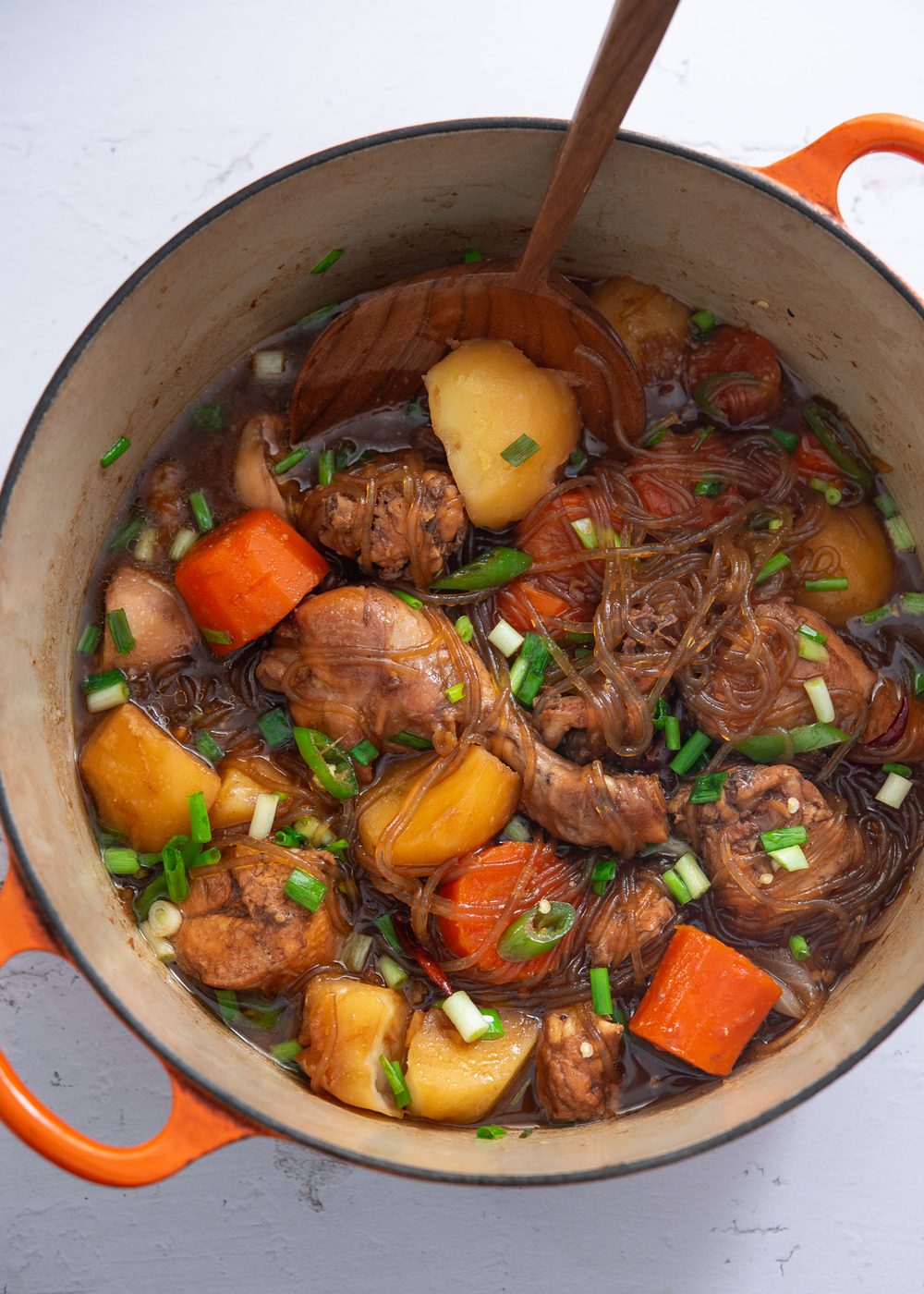 Andong-style jjimdak simmered in a pot with chicken, vegetables, and noodles.
