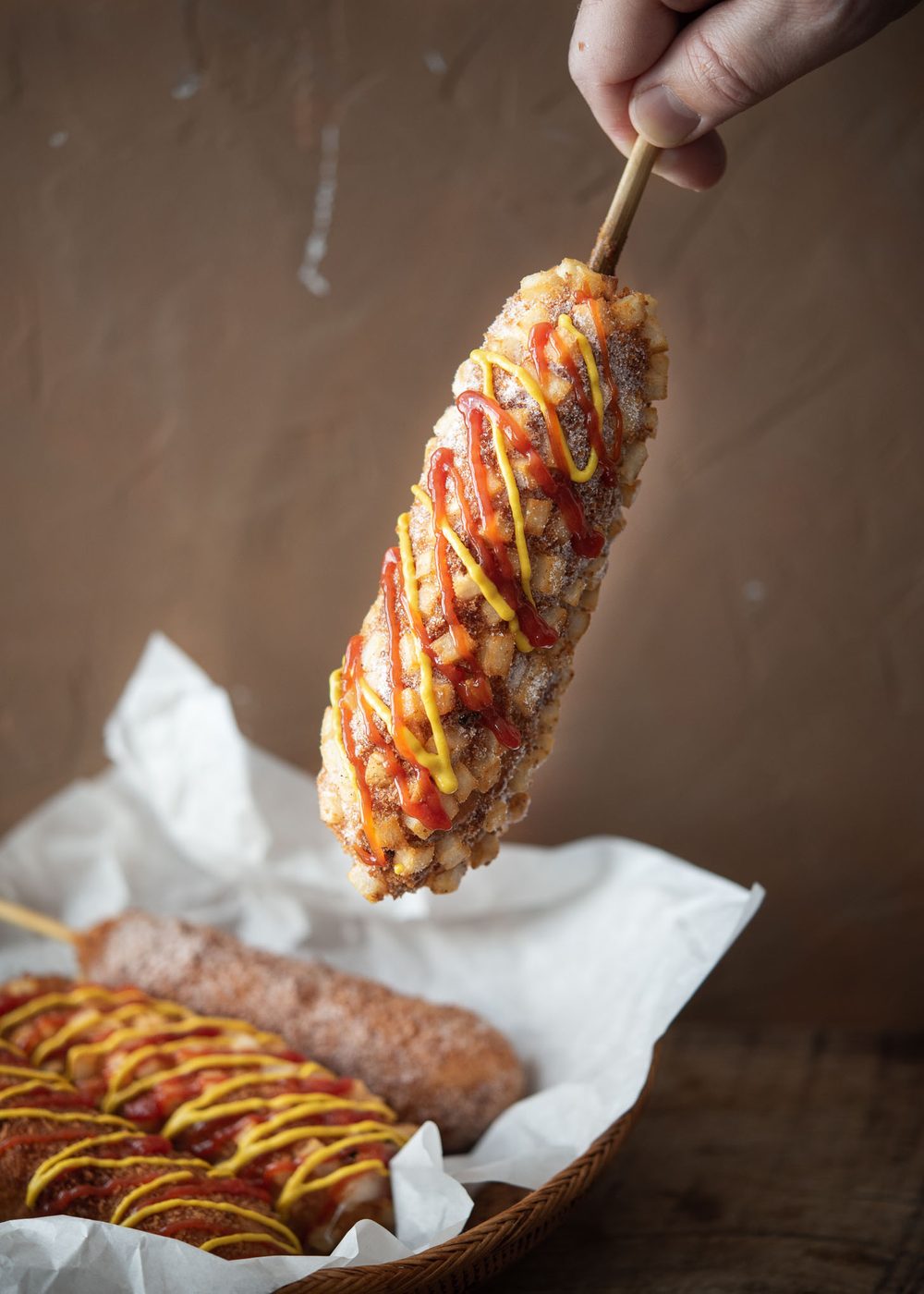 Crispy potato Korean corn dog with sweet and savory condiments