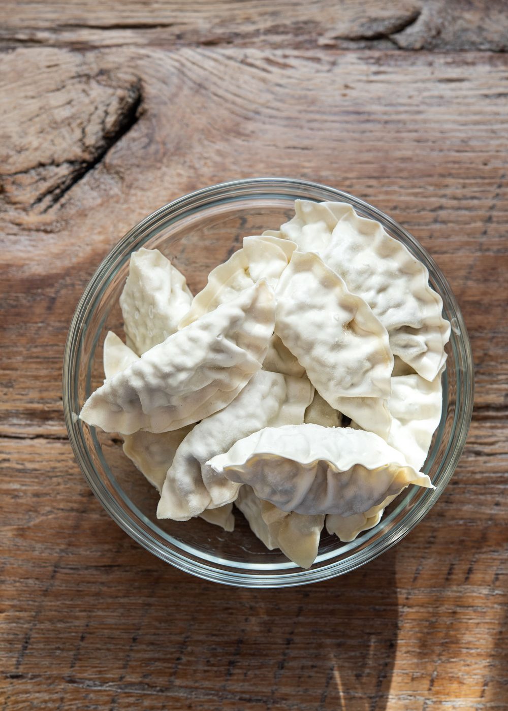 Frozen Korean mandu in a bowl, prepared for making Mandu-guk