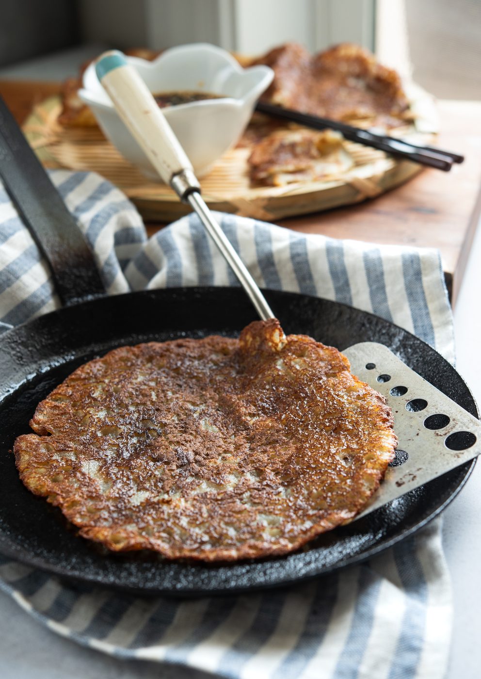 Korean potato pancakes are pan-fried to golden crisp in a skillet