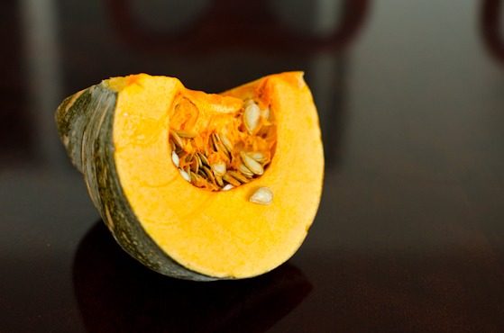 A chunk of sliced fall pumpkin is placed on a table