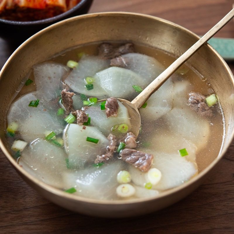 Beef radish soup in a bowl with a spoon.