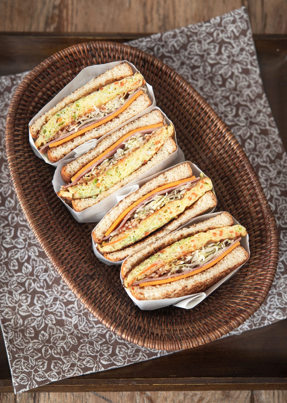 Wrapped Korean street toasts are cut in half and served in a small basket