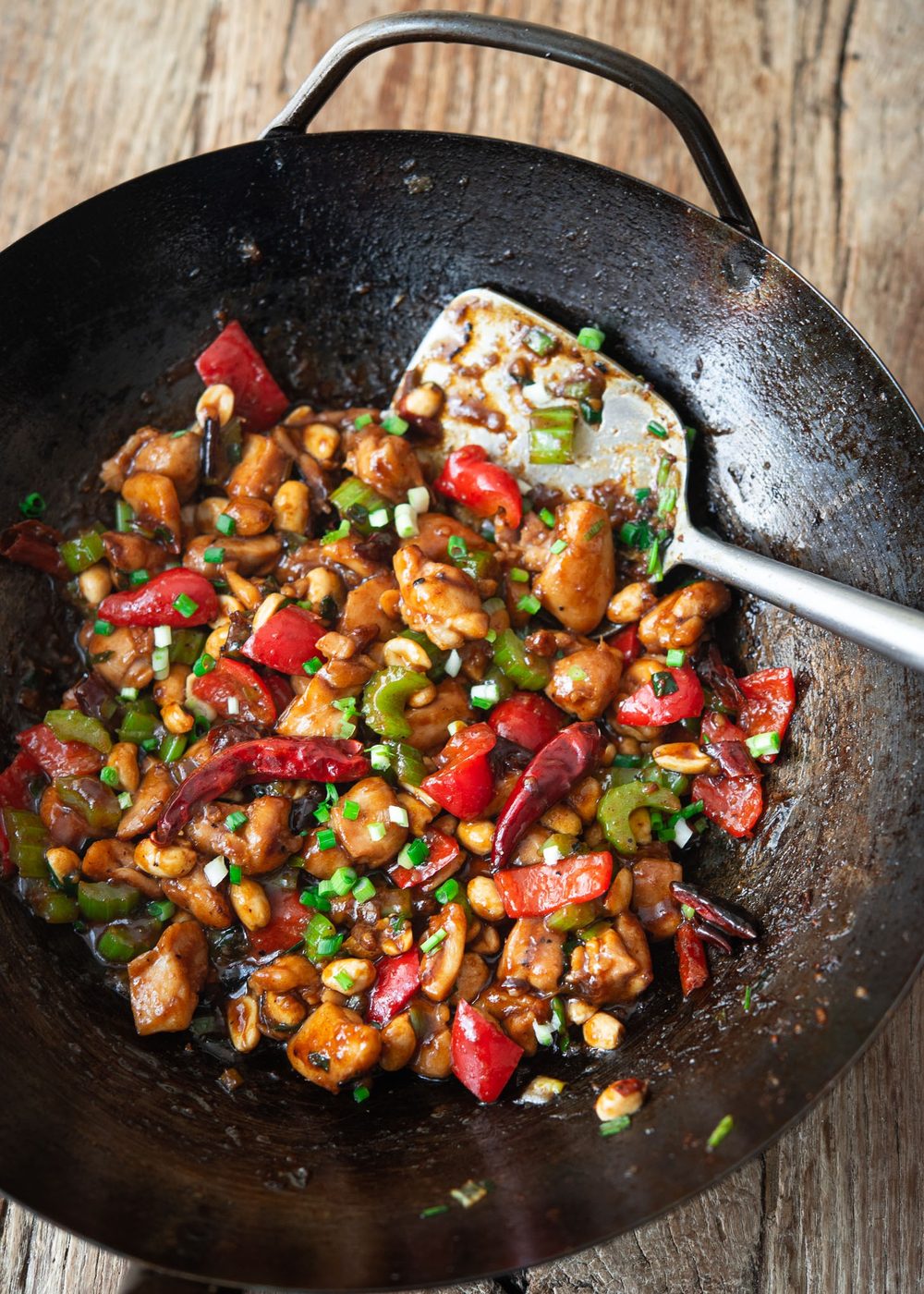 Classic Kung Pao Chicken stir-fried in a hot wok with dried chilies and peanuts