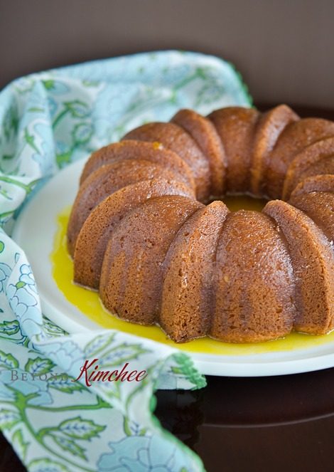 Orange cake with kitchen-made orange sauce on a platter.