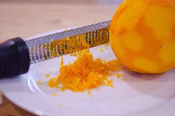 An orange is zested.