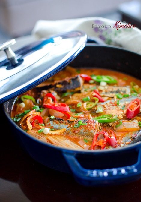 Kimchi Jjigae is made with canned mackerel pike fish in a blue pot.