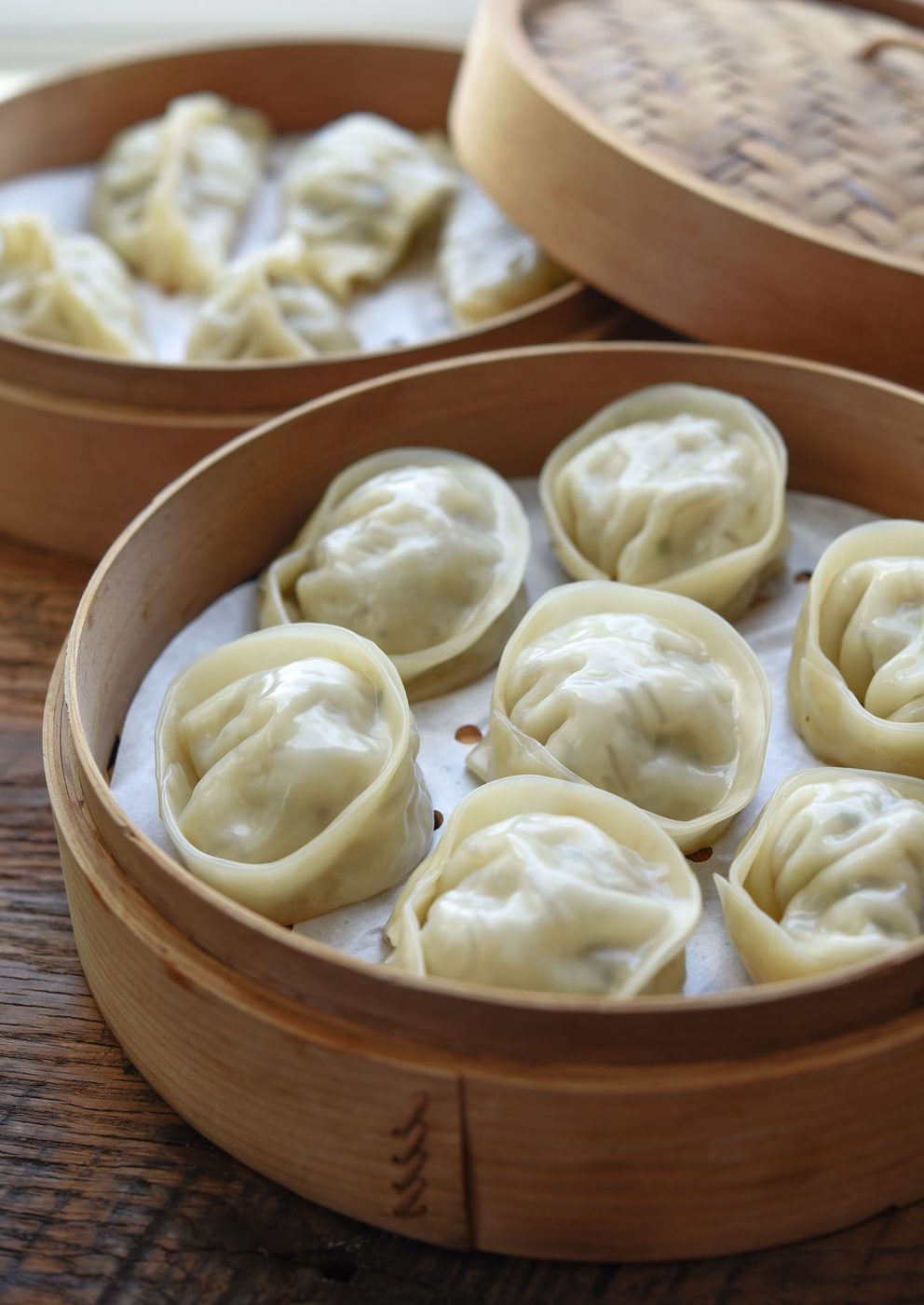 Mandu (Korean dumplings) steamed in bamboo baskets.