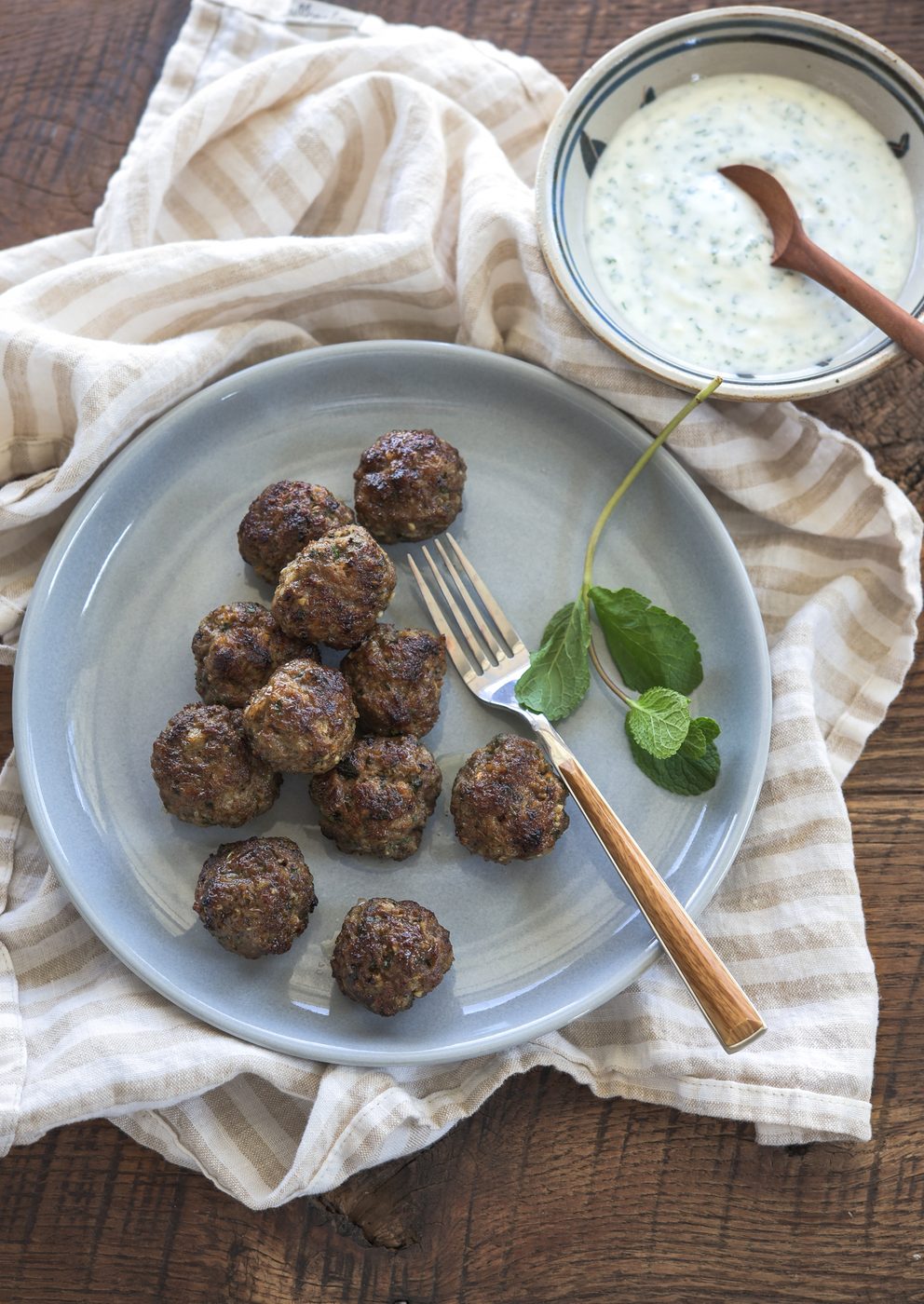 Middle eastern meatballs are served with mint yogurt dip