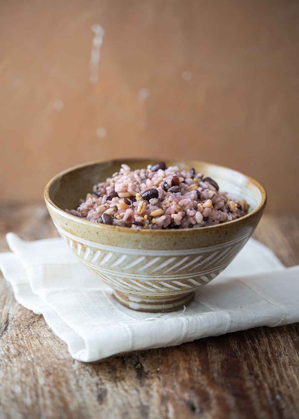 Bowl of Korean multigrain rice (japgokbap) made with 7 grains including white rice, millet, barley, black rice, and oats.